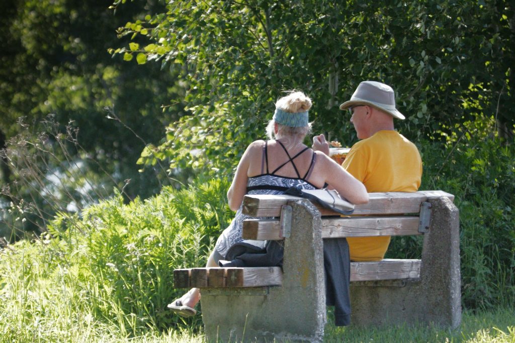 a man and a woman sitting on a bench